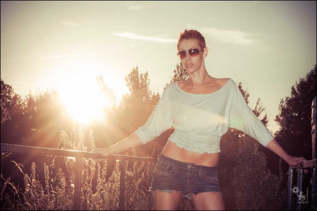 Cool Summer - Fantastic Summer Portrait with cool model wearing sunglasses and a short jeans Miniskirt with the sun shining into the camera - © by Magistus