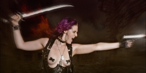 Speed Fight - Erotic Fightergirl Action-Composing with fantastic girl with colorful hair wearing a balck corsage showing her tits with nipples taped with crosses posing with a gun and a sword in front of an explosion - Composing © by Magistus - Background by BrownzArt http://brownzart.wordpress.com