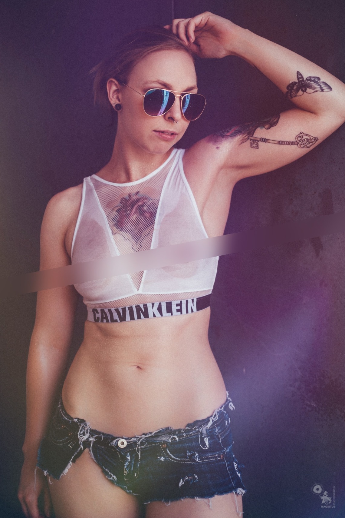 Super sexy tattoo girl showing her boobs wearing a seethrough wetlook top